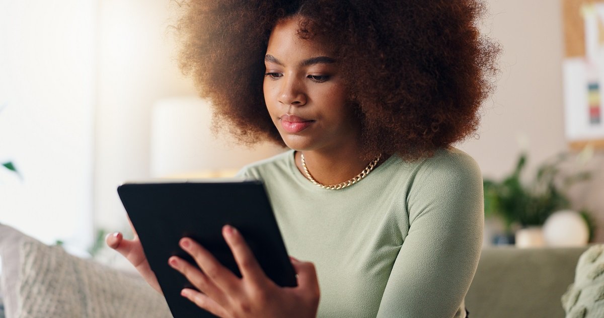 Tablet, home and African woman
